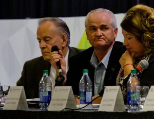 Benoit holds his microphone during the Lloydminster Chamber of Commerce all-candidates forum. Photo by James Wood/106.1 The Goat/Vista Radio