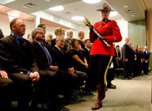 Sgt. Sarah Knelsen walks the ceremonial mace of Lloydminster past the seated council members before they stood to be sworn in. Photo by James Wood/106.1 The Goat/Vista Radio 