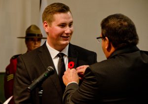 Councillor Jonathan Torresan has his City of Lloydminster pin placed on his suit by Lloydminster mayor Gerald Aalbers. Photo by James Wood/106.1 The Goat/Vista Radio