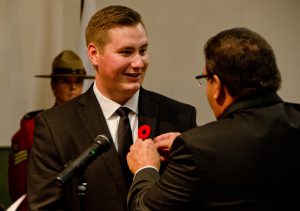 Councillor Jonathan Torresan has his City of Lloydminster pin placed on his suit by Lloydminster mayor Gerald Aalbers. Photo by James Wood/106.1 The Goat/Vista Radio 