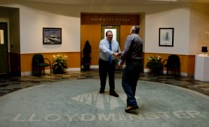 A municipal worker shakes hands with Mayor Gerald Aalbers while passing through City Hall. Photo by James Wood/106.1 The Goat/Vista Radio 
