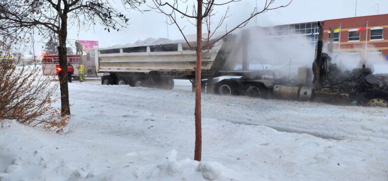 Snow hauling semi engulfed in flames
