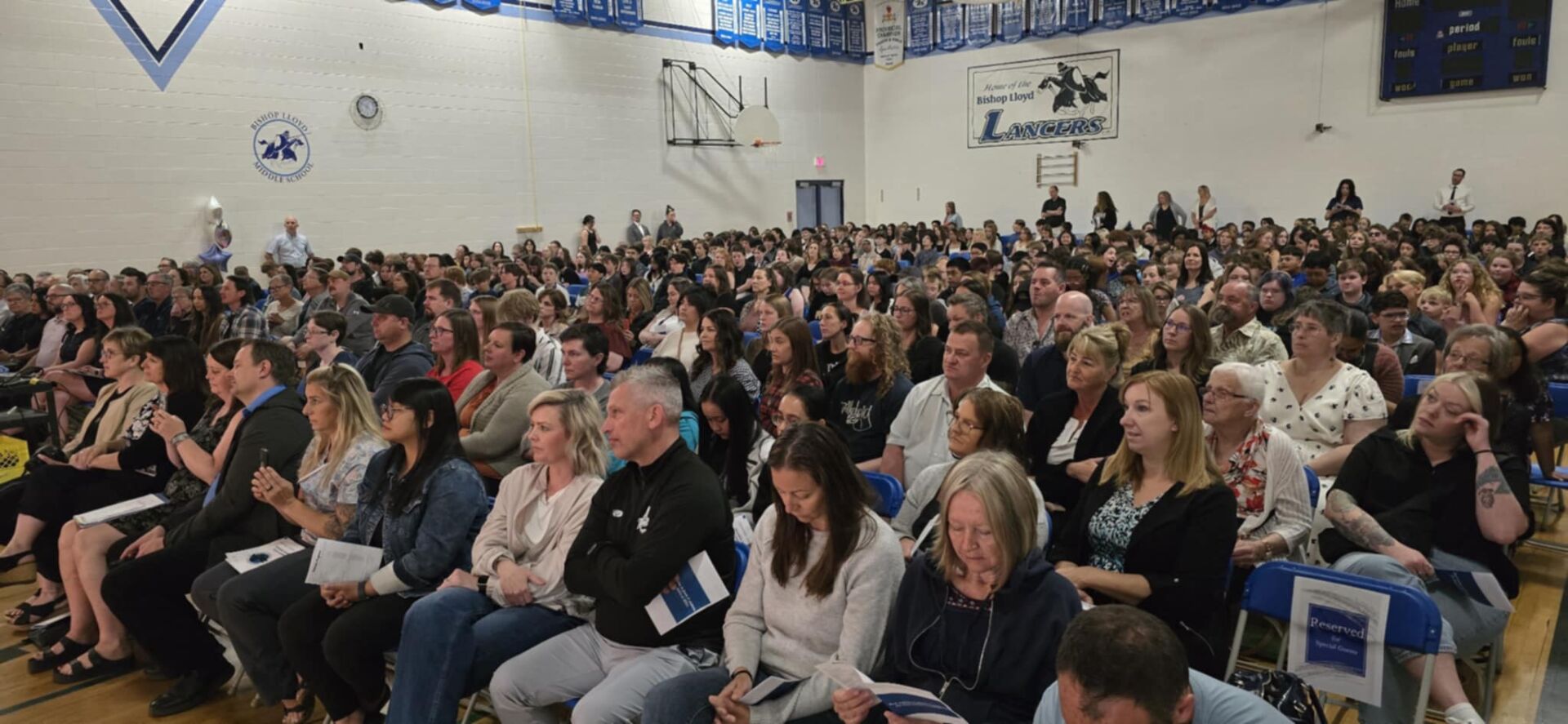 Family members and well wishers fill the school gym at Bishop Lloyd Middle School