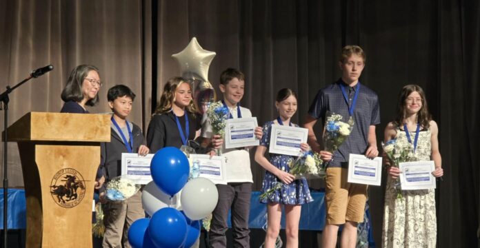 Photo of group on stage accepting award