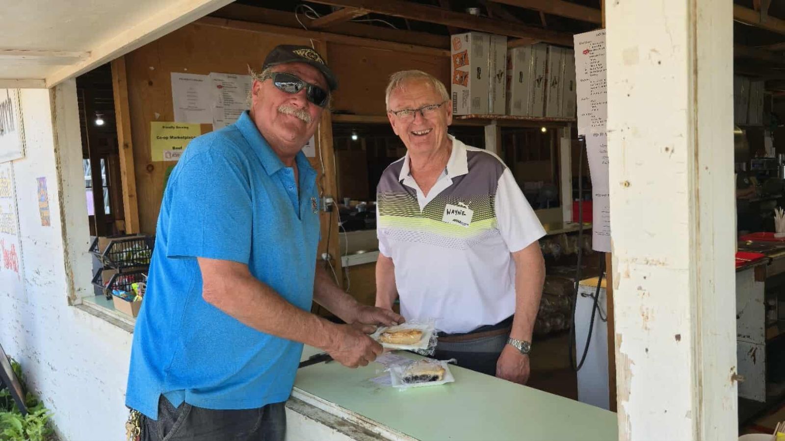 Volunteer serving pie at the Grace United food booth at the Lloyd Ex Fair.