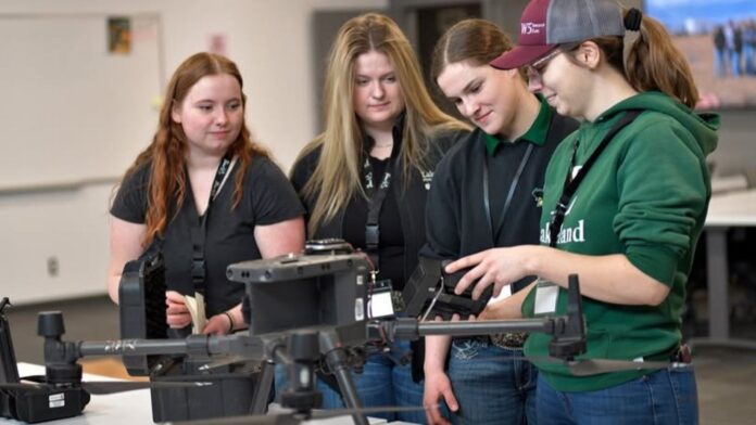 Lakeland College BAT students working with a drone.