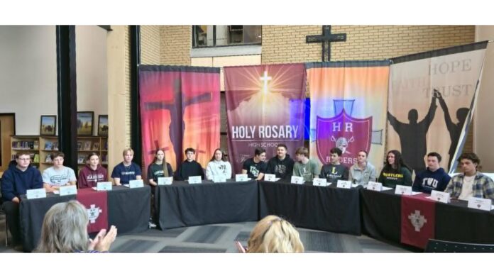 Holy Rosary High School athletes in Lloydminster sign up for post-secondary. | Photo: 106.1 The Goat/Vista Radio.