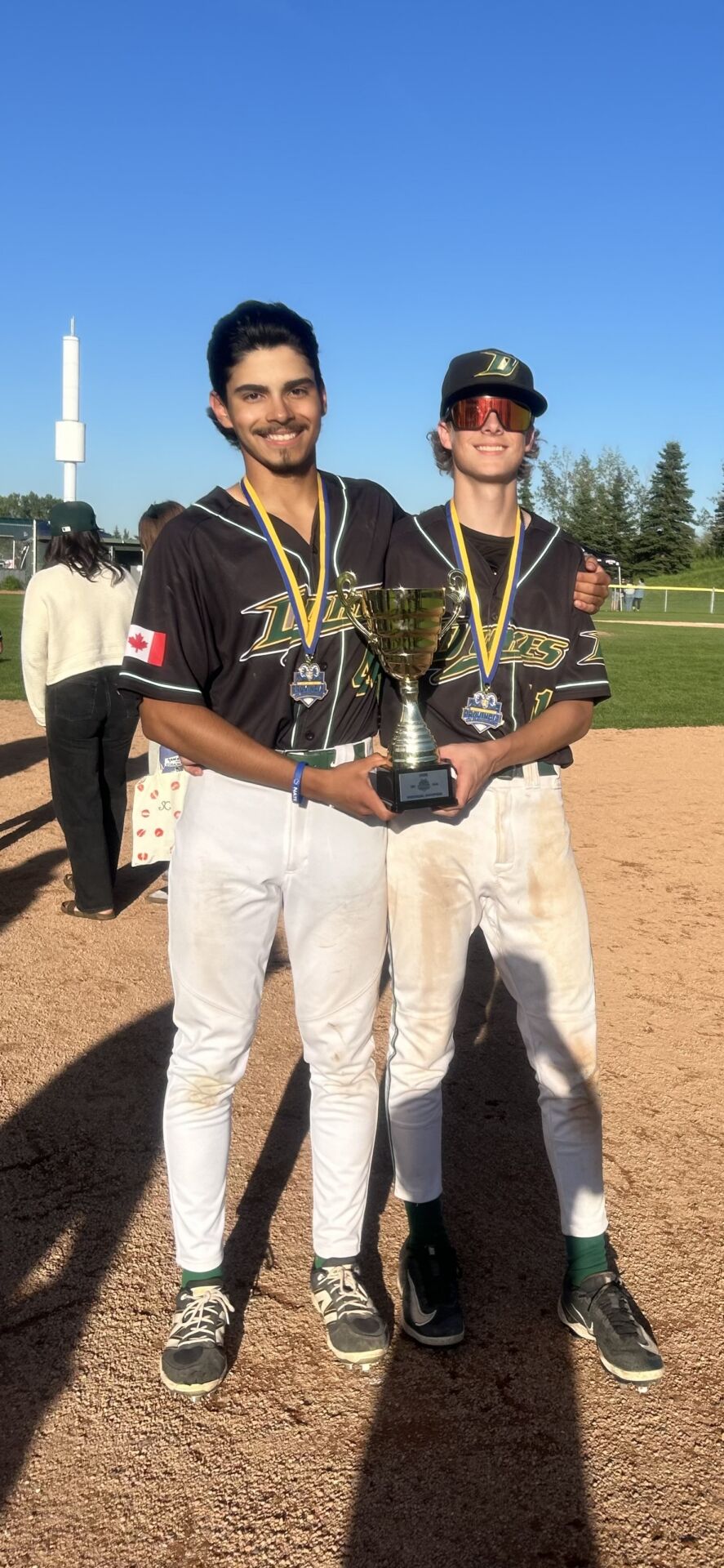 Dario Valera (L), and Conner Frerichs of Lloydminster on board for Sherwood Park Dukes provincial baseball win. | Photo: Kyle Stang.